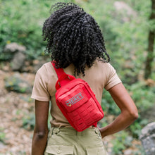 Load image into Gallery viewer, Person wearing a red backpack with 'Ceret' branding in a natural setting